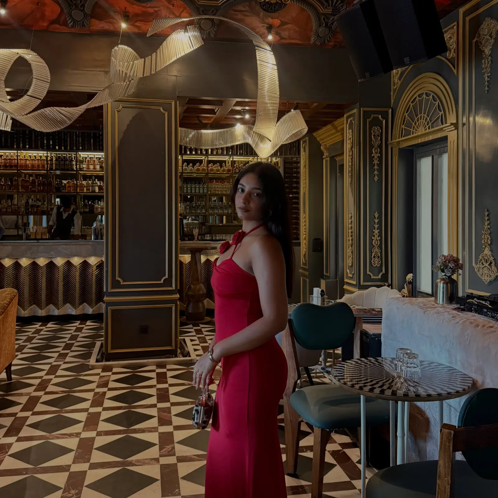 Vanshika Tanwani in a hot pink halter maxi dress inside an ornate café in C-Scheme, Jaipur